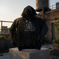 Black hoodie with 'Ripp by God' logo on a rooftop with industrial background